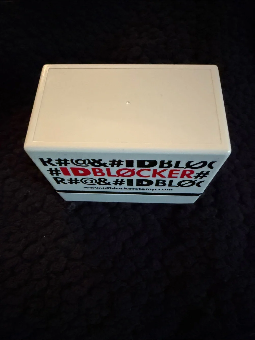 White and Black IDBLOCKER Stamp with Red Logo